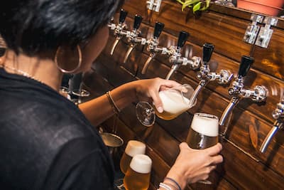 Person pouring beer from a tap